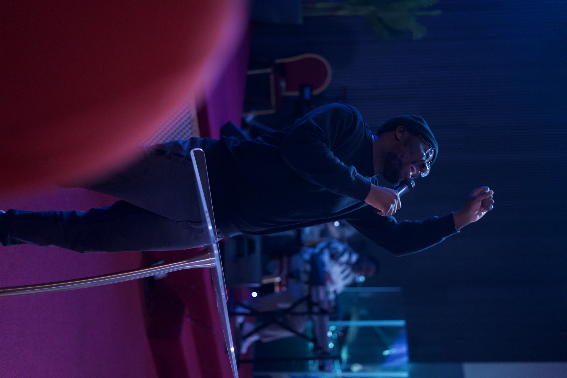 A young man worshipping with his hand raised at Embassy