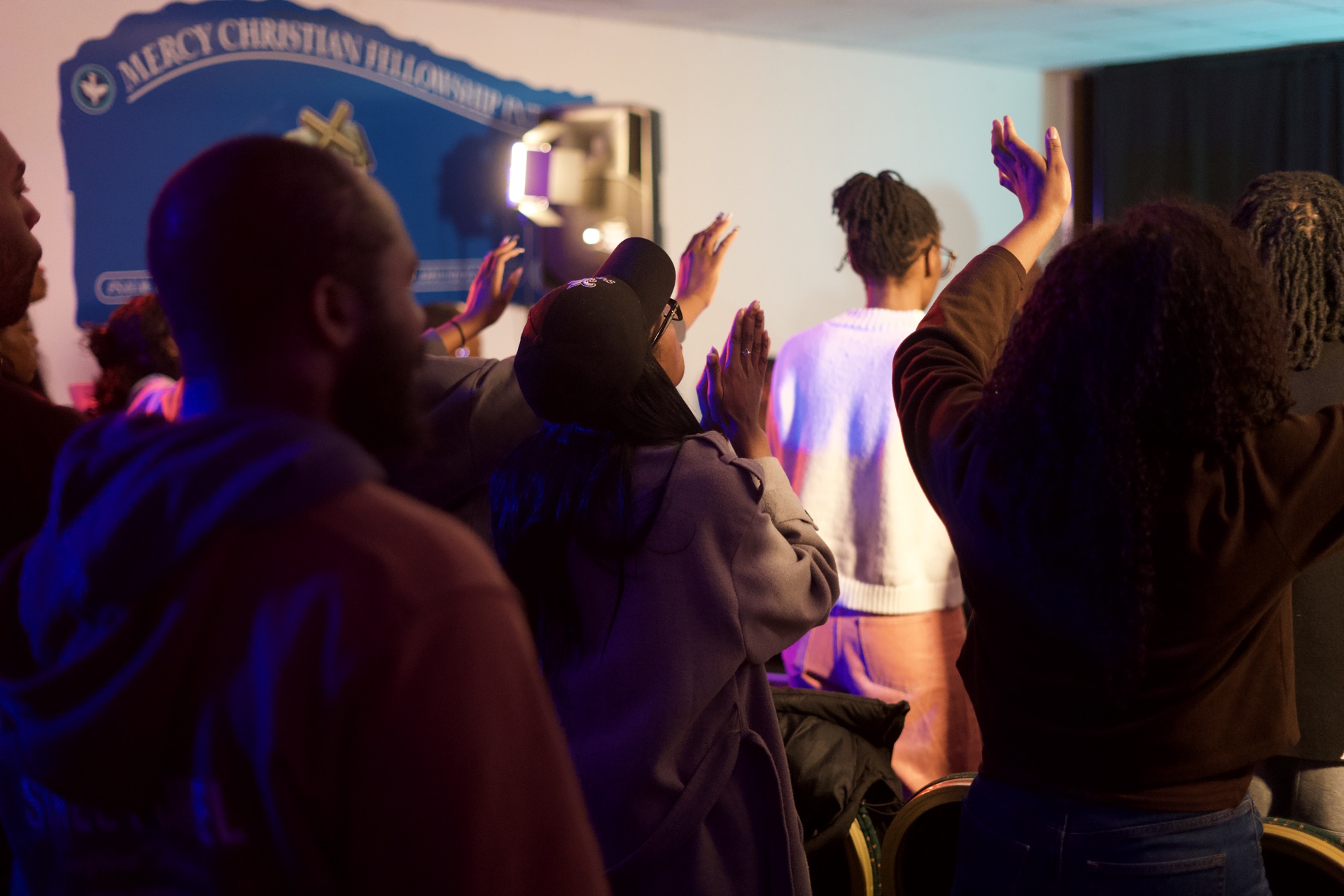 The congregation worshipping with hands raised